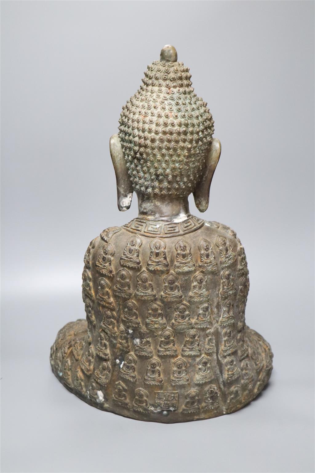 A large bronze Buddha, a Chinese cloisonne enamel figure and a hardstone vase and cover, tallest being 43cm high